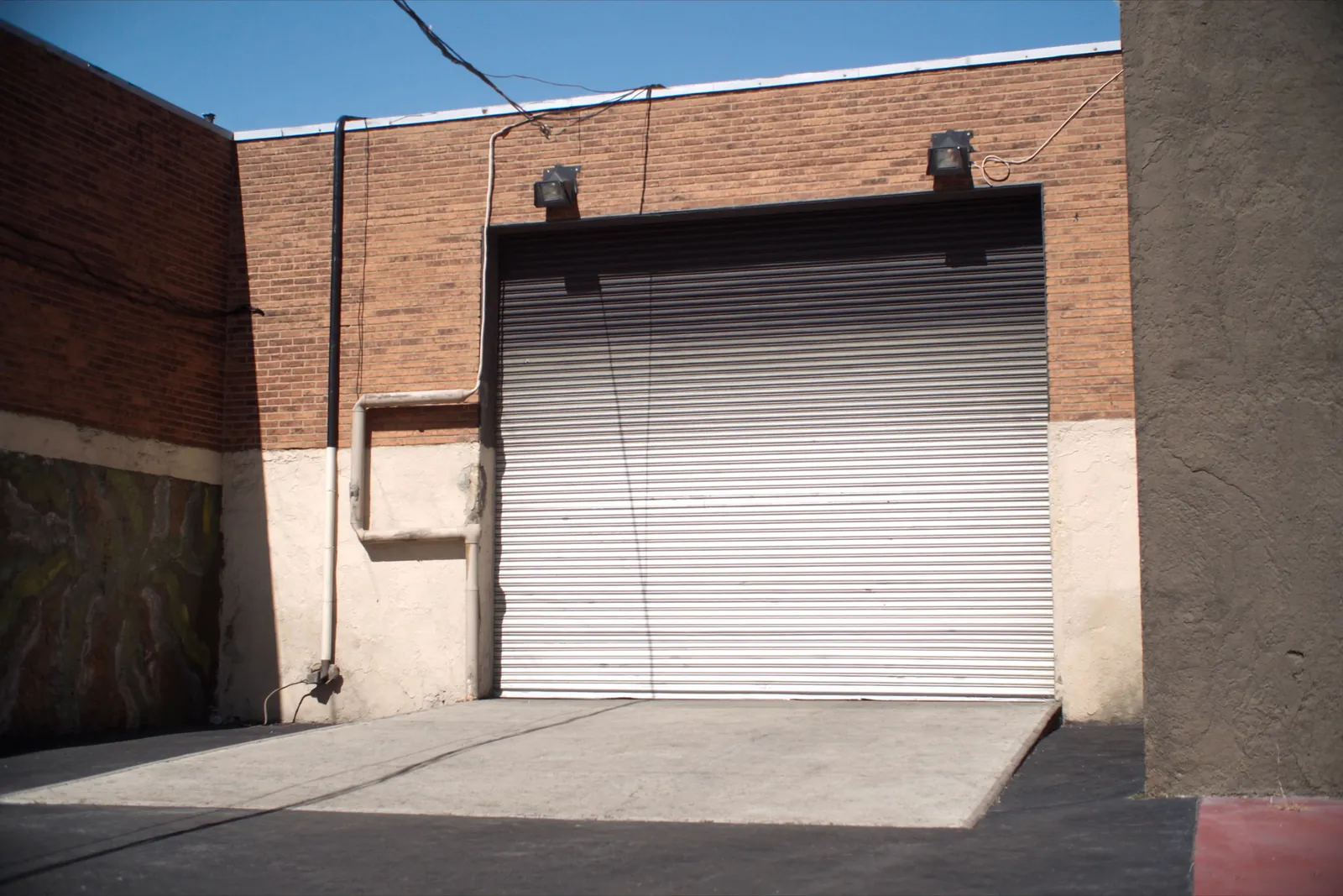 Steel roll-up door in the brick wall of a commercial building