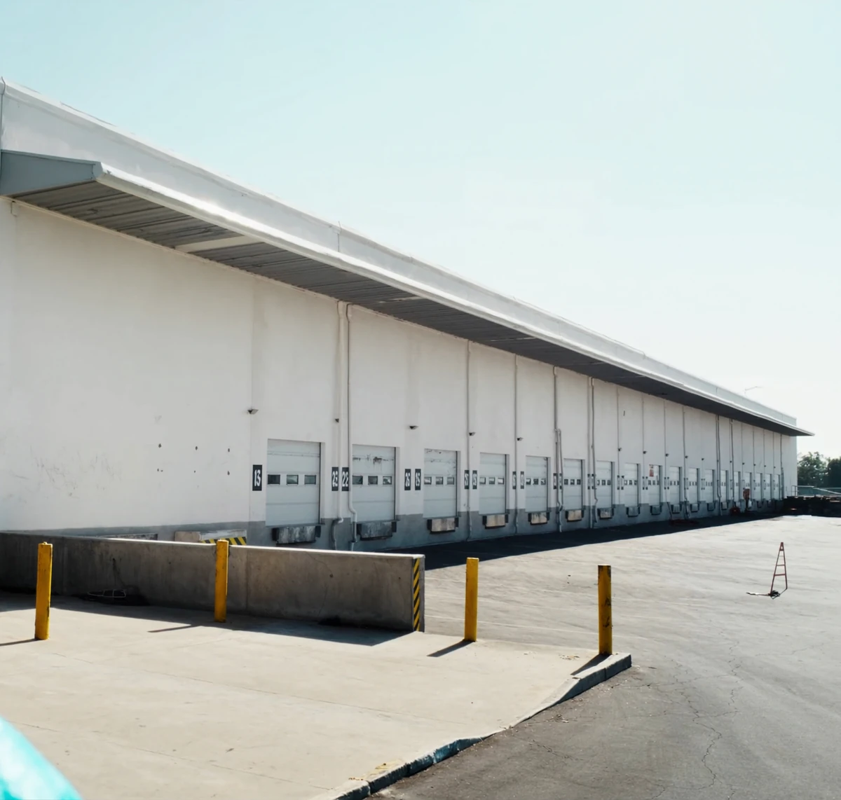 Long warehouse wall with a row of loading dock doors