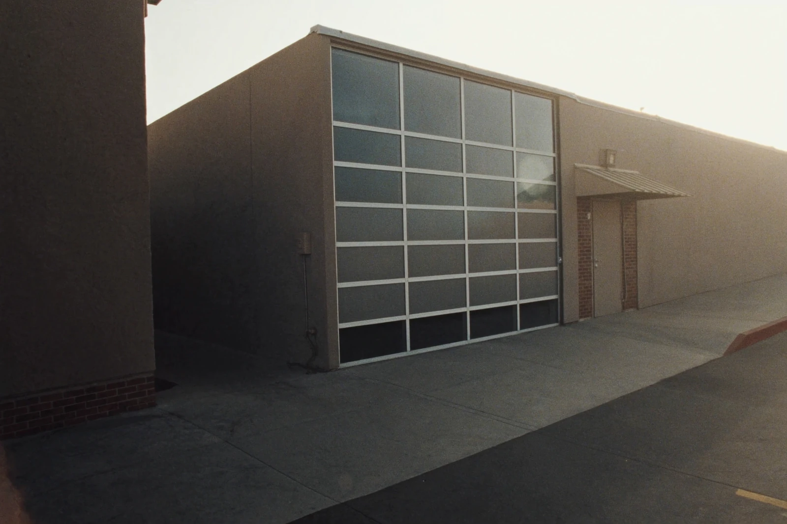 Commercial building with a tall glass-panel aluminum overhead door