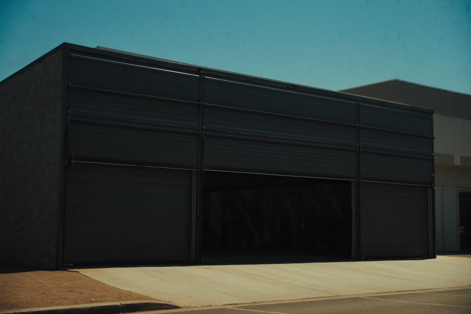 Dark steel overhead door on a small commercial building