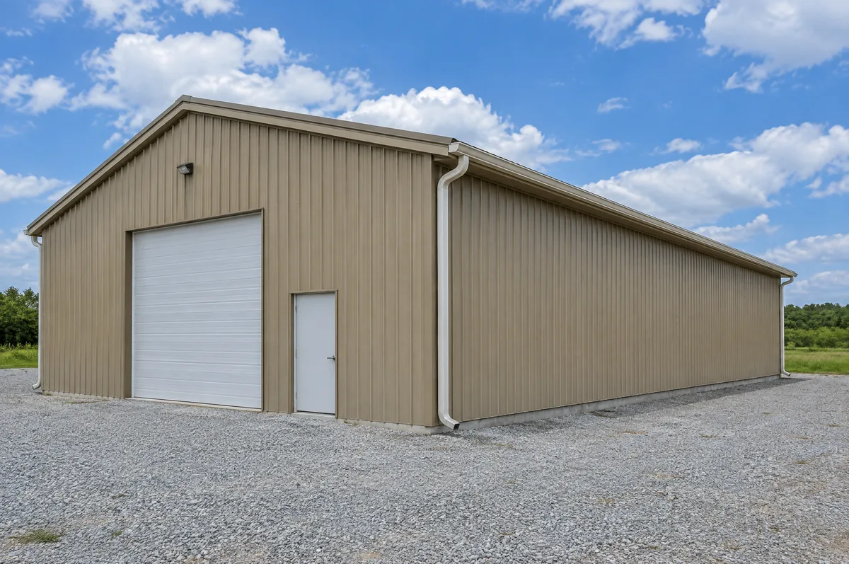 Metal warehouse building with gutters and corner downspouts