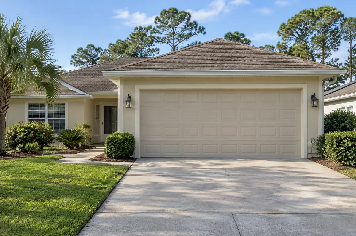 Stucco home with an almond raised-panel garage door
