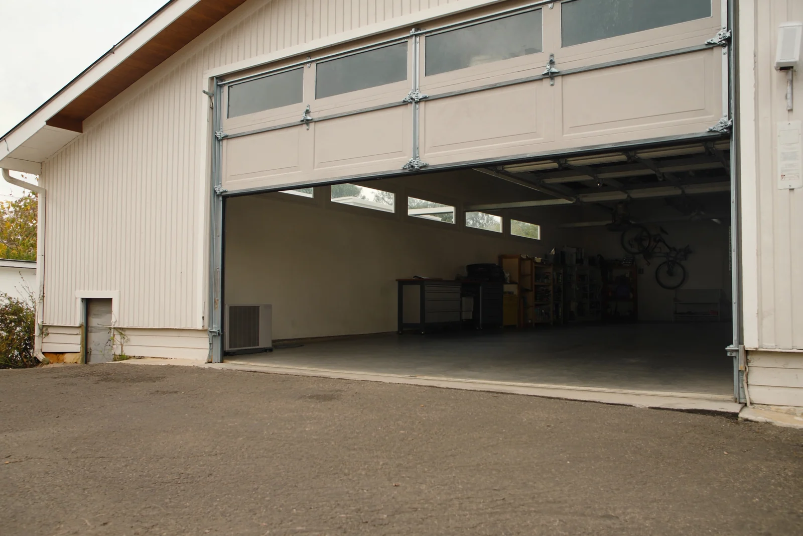 White sectional garage door with a window row raised to show a clean garage