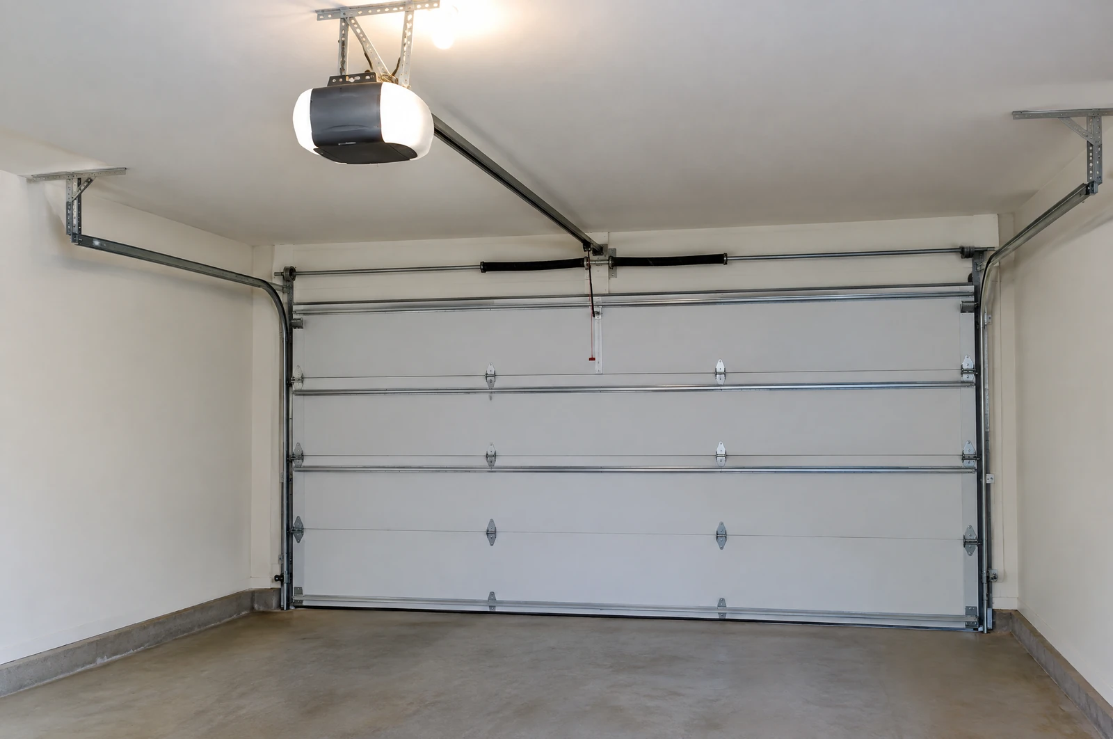 Garage door opener and rail mounted on a garage ceiling