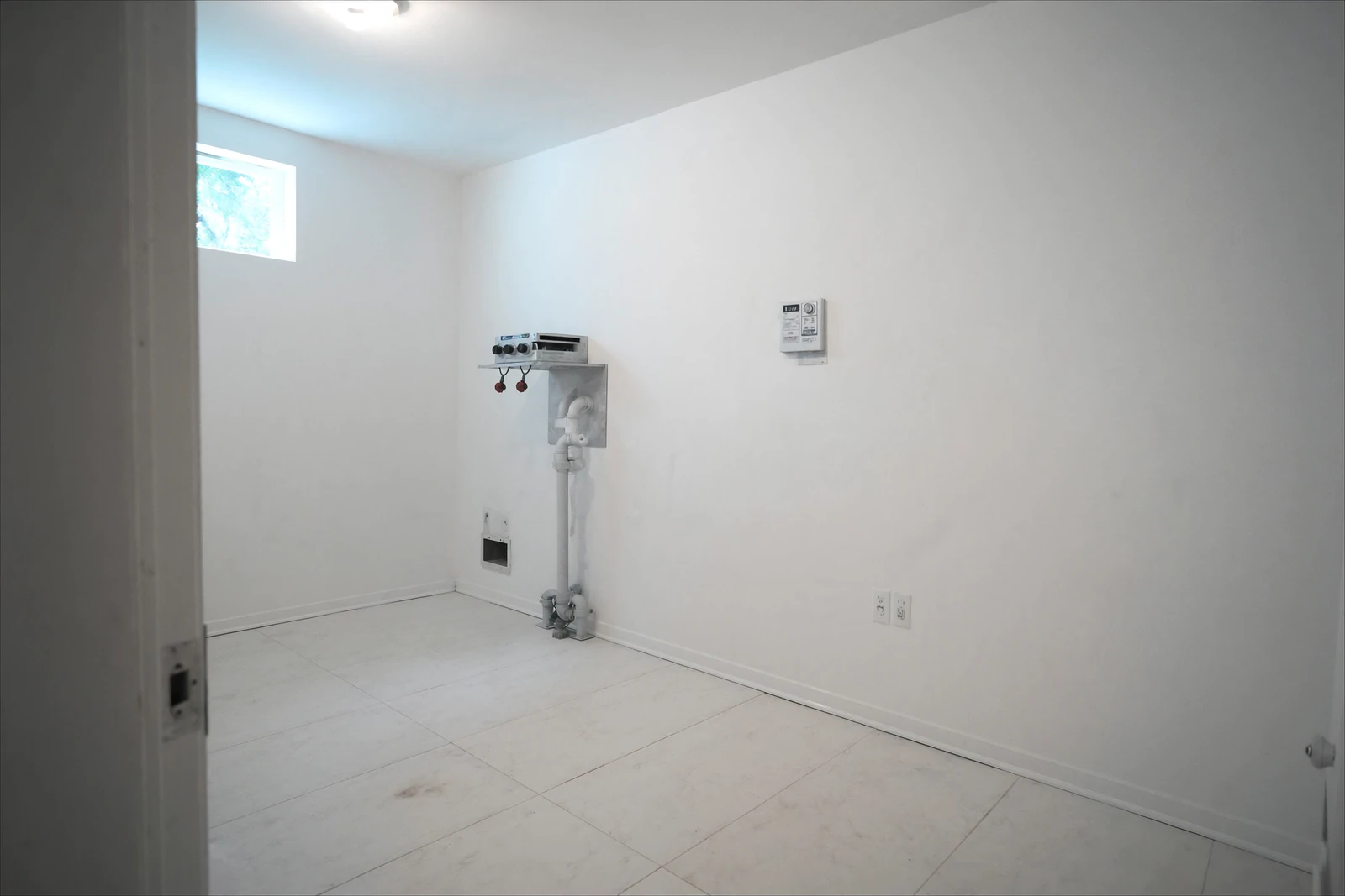 Empty laundry room with washer hookups in a newly finished house