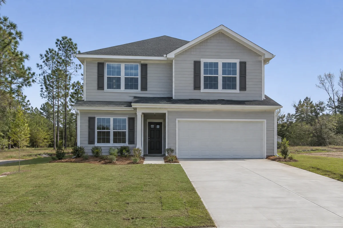 Newly built two-story home with fresh sod and a new driveway