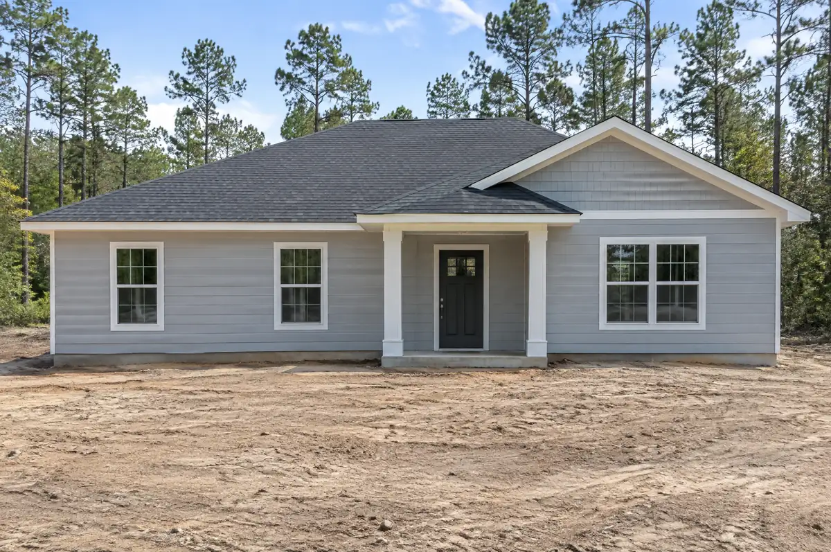 New single-story house with the outside finished and the yard not yet landscaped